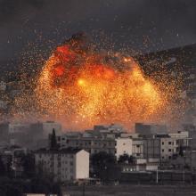 An explosion rocks Kobani during a reported suicide car bomb attack by ISIS.